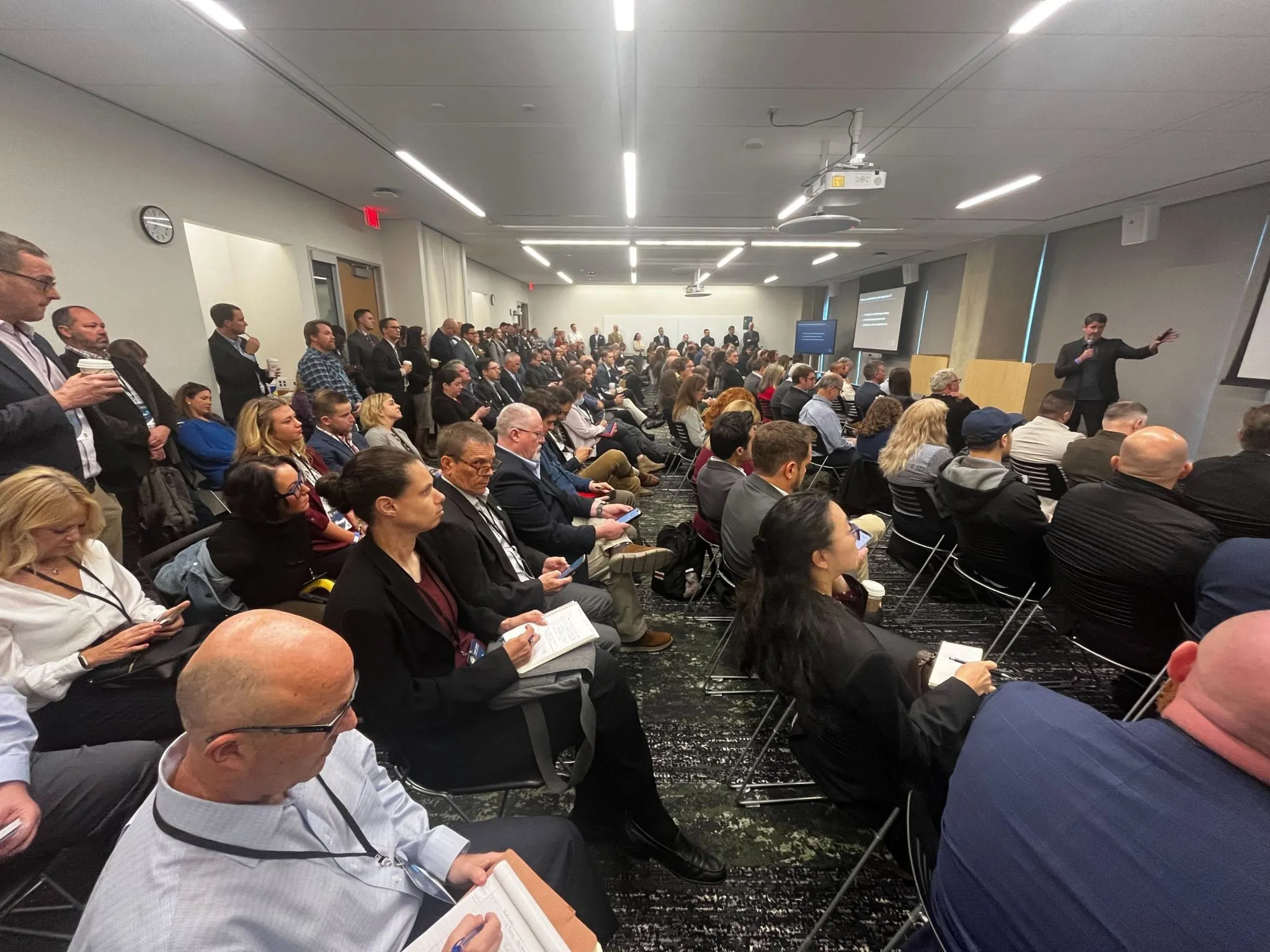 Cory Bergman delivering an AI keynote to a packed room at a regional OSAC event